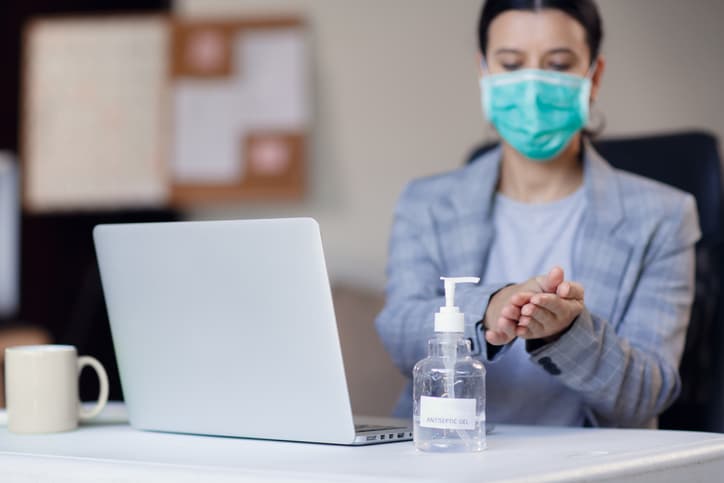 Woman-in-office-hand-sanitizer