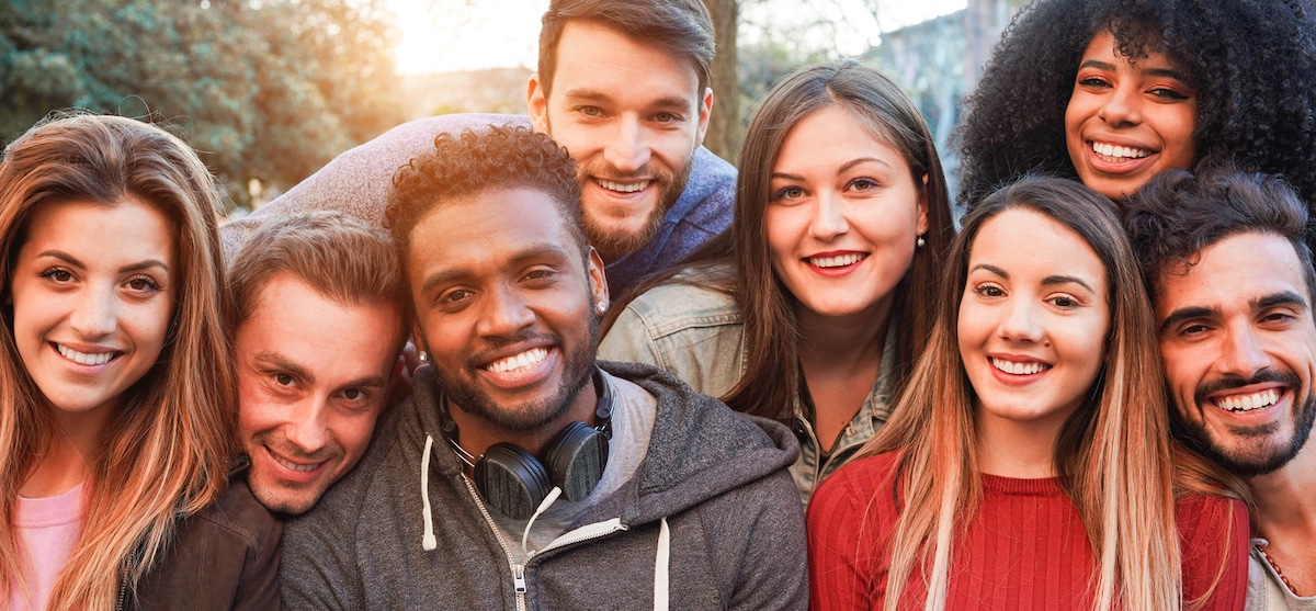 Smiling friends posing together while on a group vacation