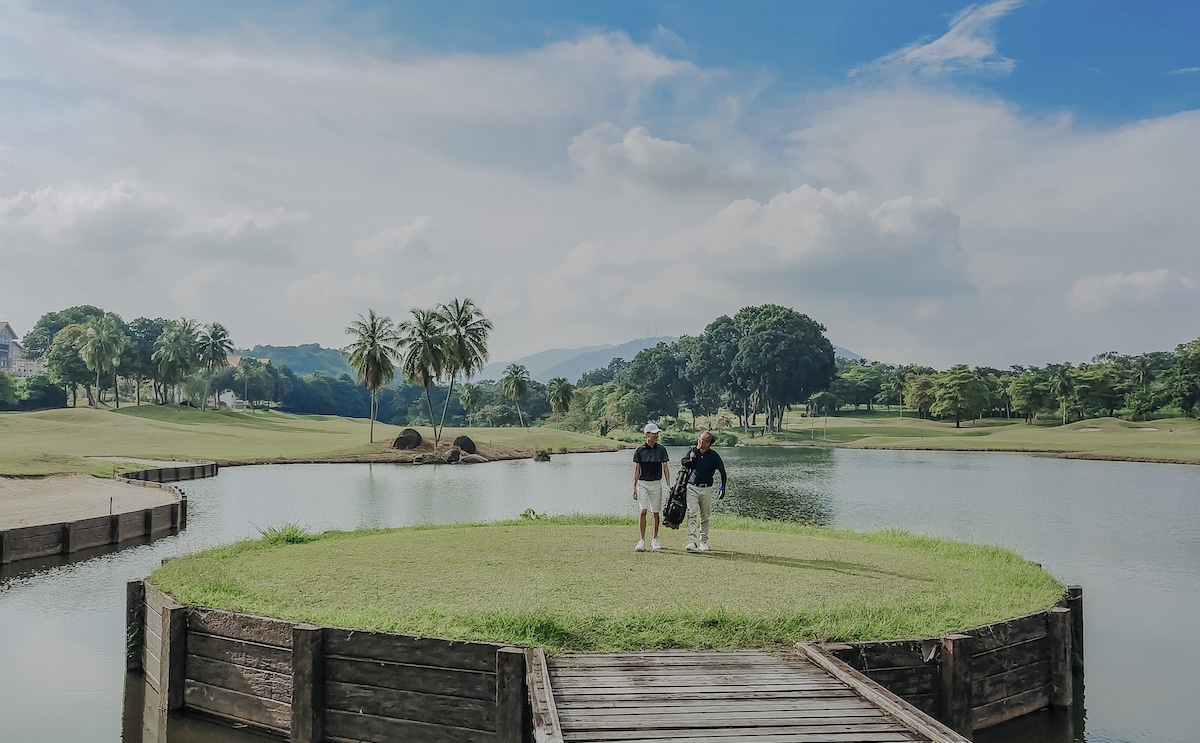 Playing golf from island on course in malaysia