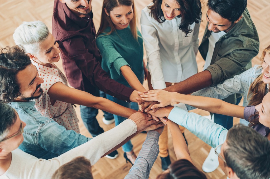 people-putting-hands-in-a-circle