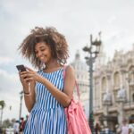 Woman-using-smartphone-in-foreign-country